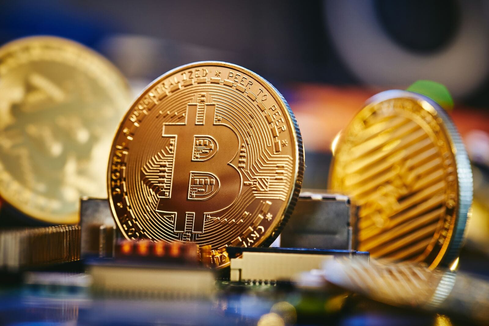 Close-up of a gold coin on a circuit board, representing the modern language of fintech and business credit